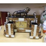 An Art Deco clock garniture, with bronze lion mount by Hugues, clock 36cm high