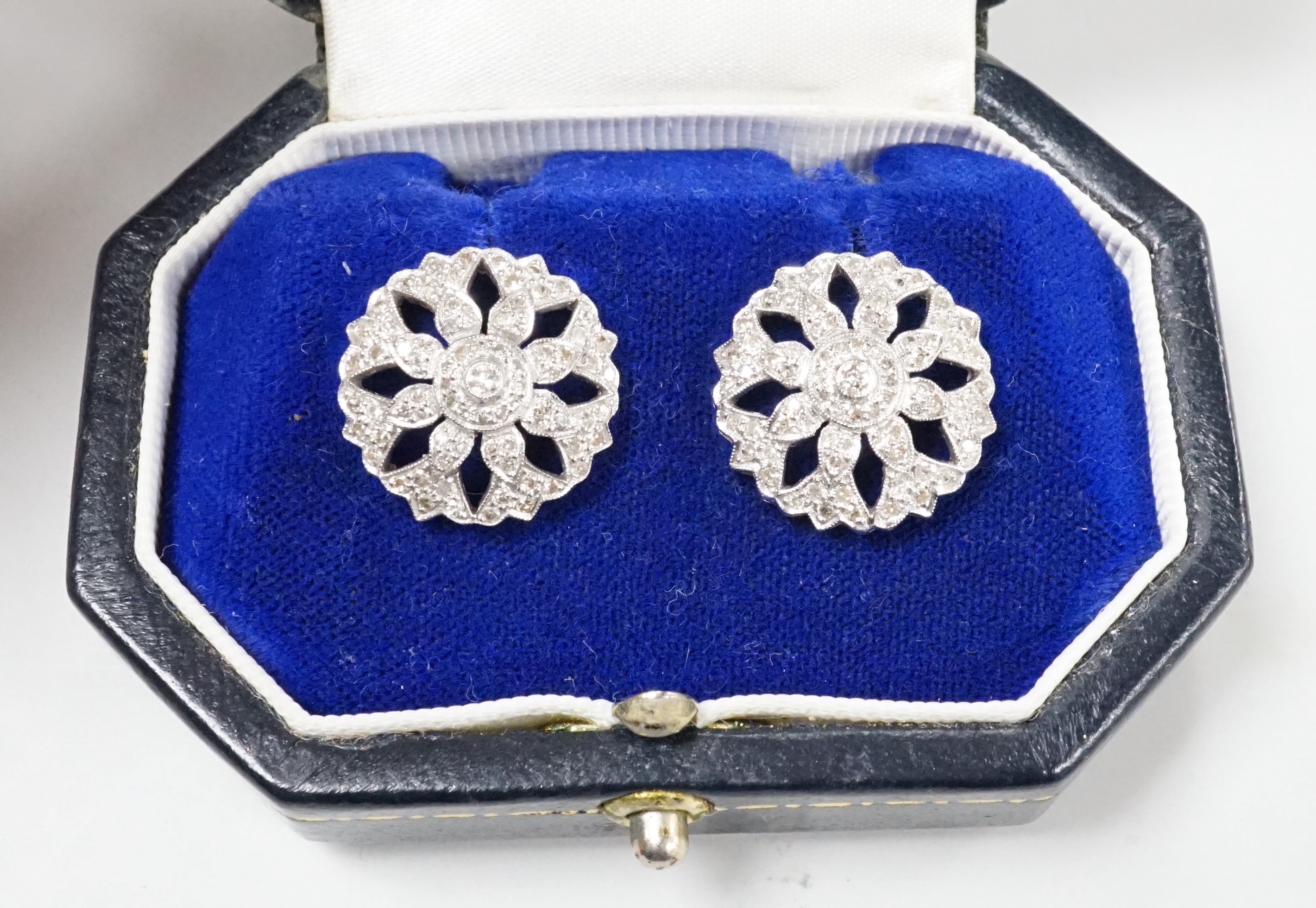 A pair of pierced white metal and diamond set circular cluster earrings, diameter 17mm, with 925