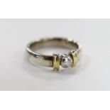 A modern two colour 9ct gold and single stone diamond set ring, size V/W, gross weight 9.1 grams.