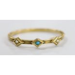 An Edwardian reeded yellow metal, turquoise and split pearl set three stone hinged bangle,