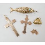 Two early 20th century 9ct gold cross pendants, three other 9ct charms including articulated fish,