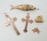 Two early 20th century 9ct gold cross pendants, three other 9ct charms including articulated fish,
