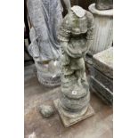 A reconstituted stone garden statue of a lady holding a dove, head detached, height 95cm