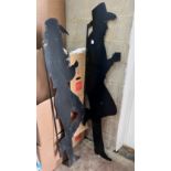 A pair of black painted iron silhouettes of cowboys, largest 177cm