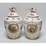 Two Dresden porcelain vases with bird decoration finials, and central horse scenes display, 30cm