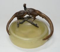 A cold painted bronze ‘pheasant’ mounted onyx ashtray, 17cm wide