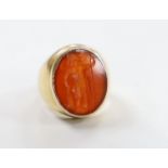 An antique yellow metal intaglio carnelian set ring, carved with a Roman soldier, size F/G, gross