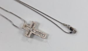 A modern 750 white metal, baguette and round cut diamond cluster set cross pendant, 23mm, gross 3.