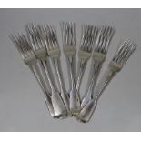 A harlequin set of seven George IV/William IV silver fiddle pattern table forks, including five by