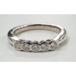 A modern 18ct white gold and five stone collet set diamond ring, size M, gross weight 5 grams.