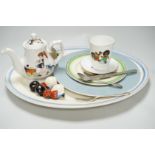 A quantity of golly china to include early green golly and a wooden doll part tea set