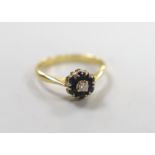 A modern yellow metal, sapphire and diamond cluster set ring, size M, gross weight 2.8 grams.