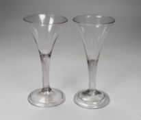 Two George II ‘drawn trumpet’ wine glasses, folded feet, tallest 16.5cm