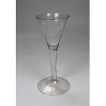 A George II drawn trumpet wine glass, folded foot, 18cm tall