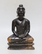 A Javanese carved wooden Buddha, 23cm tall