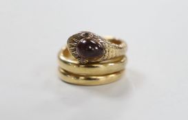 A yellow metal and garnet set coiled serpent ring, with diamond chip eyes, size P, gross weight 15