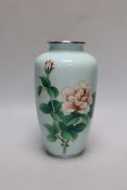 A Japanese cloisonné enamel vase decorated with roses upon a pale blue ground, silvered rim and