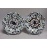 A pair of 18th-century English delftware polychrome plates, 23cm