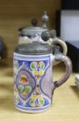 Four 18th century German faience lidded tankards and a salt glazed tankard, all with hinged pewter