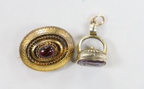 A Victorian yellow metal and single stone cabochon garnet set oval brooch, with glazed back, 29mm