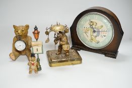 A Smith teddy bear clock, a seated metal bear holding a pocket watch, a metal standing bear with