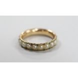 An antique yellow metal and split pearl set full eternity ring with green cabochon spacers, size K/