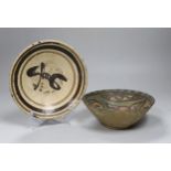 A 12th century Nishapur pottery bowl, painted with a bird, cracked and restored, together with a
