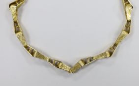 A 1970's textured 9ct gold tapered link necklace, 76cm, 57 grams.