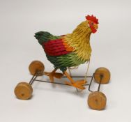 A Steiff cockerel on wooden wheel, c.1915, no button, good condition