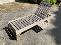 Four slatted teak sun beds, with adjustable backs and integral sliding tables, on two wheels This