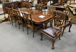 A reproduction inlaid mahogany twin pillar extending dining table, approx. 250cm extended, two spare