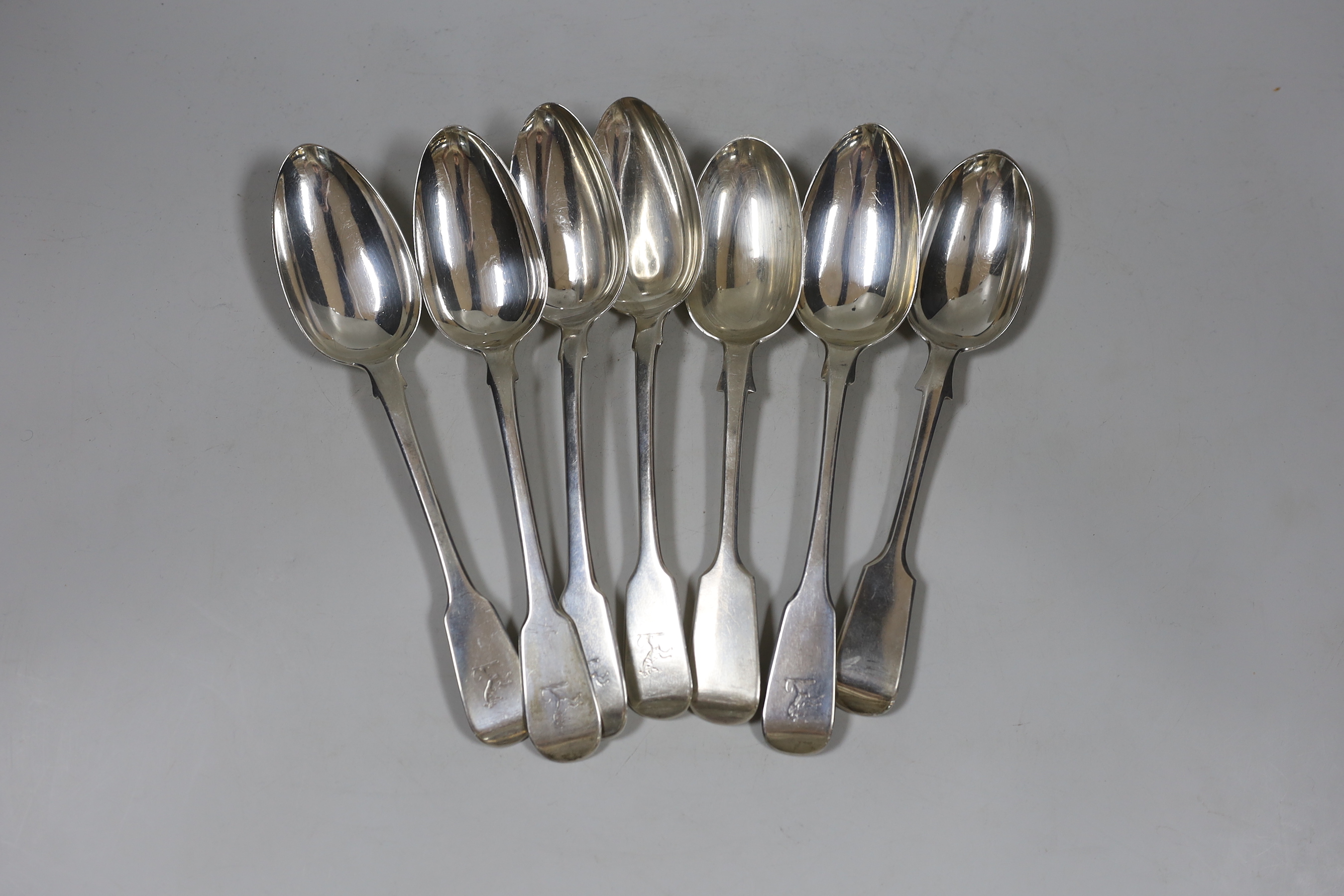 A harlequin set of seven George III and later silver fiddle pattern table spoons, various dates