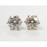 A pair of white metal and solitaire diamond set ear studs, each stone measuring approx. 5.2mm in
