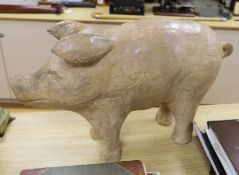 A large carved painted wooden pig, 78cm long