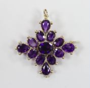 An early 20th century yellow metal and amethyst cluster set quatrefoil pendant brooch, 42mm, gross