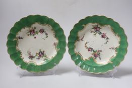 A pair of Worcester green bordered floral plates, c.1770, 21.5cm diameter