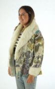 A 1940's lady's patterned brocade evening coat with white fur trim.