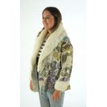 A 1940's lady's patterned brocade evening coat with white fur trim.