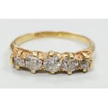 A gold and graduated five stone diamond set half hoop ring, size O/P, gross weight 2.8 grams.