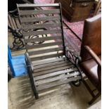 A pair of cast metal slatted wood rocking garden chairs, width 62cm, depth 86cm, height 88cm