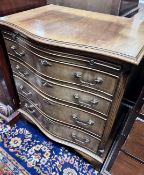 A small reproduction serpentine mahogany chest of four graduating long drawers with brushing