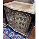 A small reproduction serpentine mahogany chest of four graduating long drawers with brushing