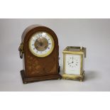 A brass presentation carriage clock together with an inlaid mahogany mantel clock