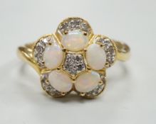 A modern 18k yellow metal, white opal and diamond chip set flower head cluster ring, size P, gross