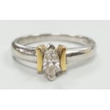 A modern two colour 18ct and solitaire marquise cut diamond set ring, size M/N, gross weight 3.6