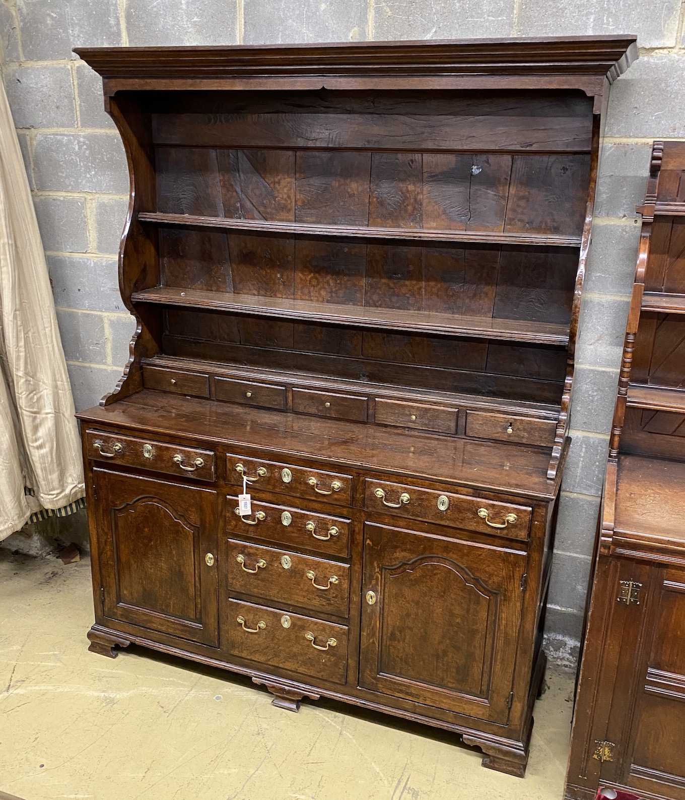 An 18th century oak dresser with boarded rack, length 158cm, depth 51cm, height 106cm