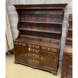 An 18th century oak dresser with boarded rack, length 158cm, depth 51cm, height 106cm