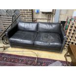 A contemporary black leather upholstered two seater sofa bed, length 172cm