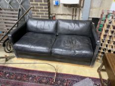 A contemporary black leather upholstered two seater sofa bed, length 172cm