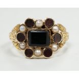 A George yellow metal, garnet and seed pearl cluster set mourning ring, with inscription dated 1799,